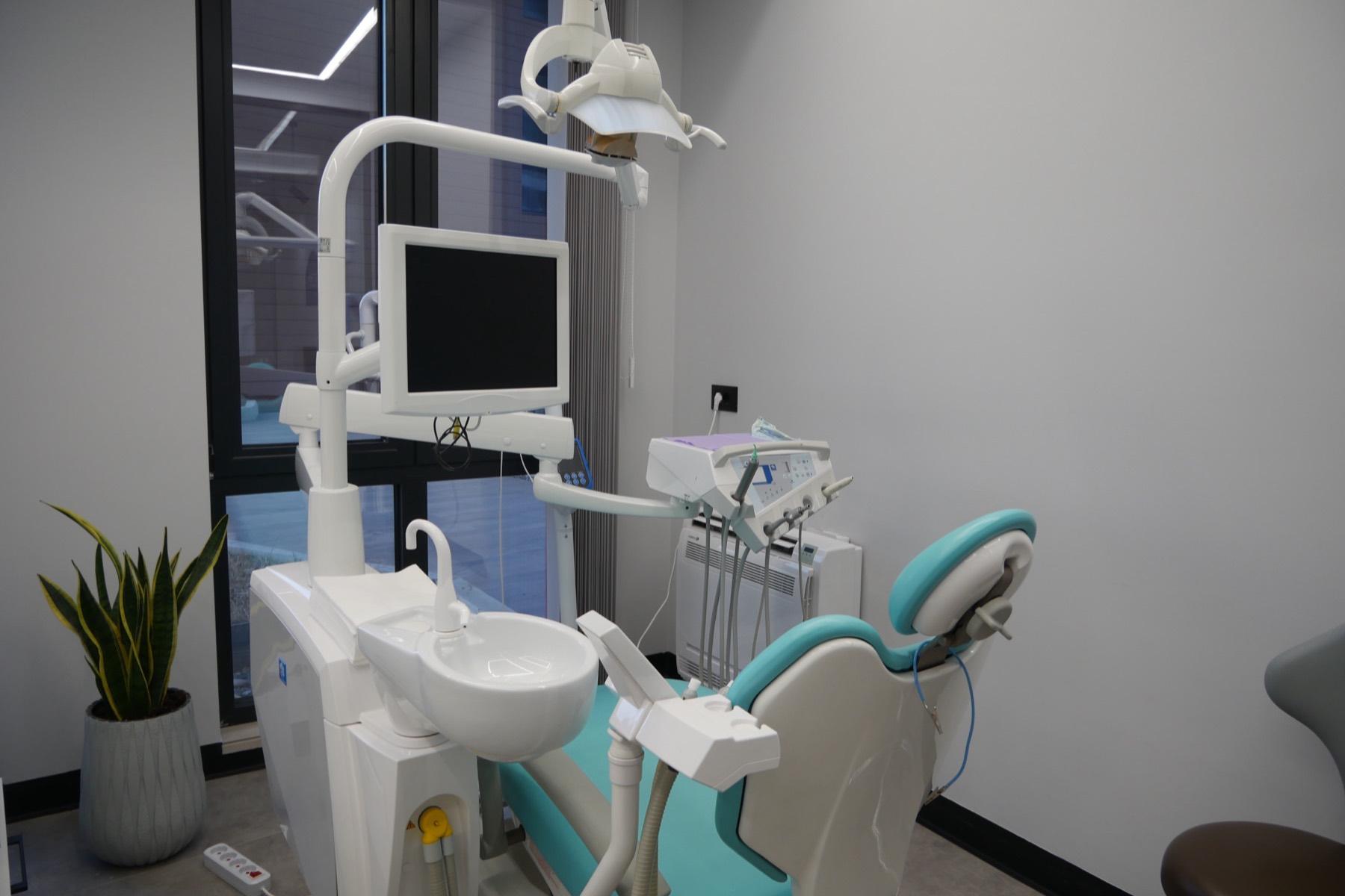Dental treatment chair in a bright, modern clinic room